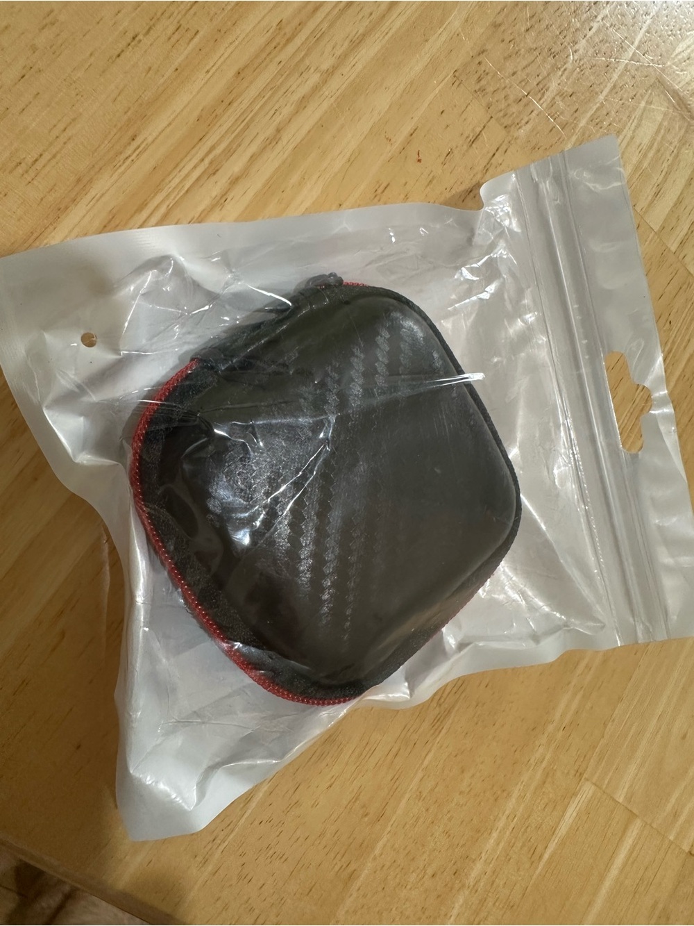Compact Black Portable Earbud Case with Red Trim
